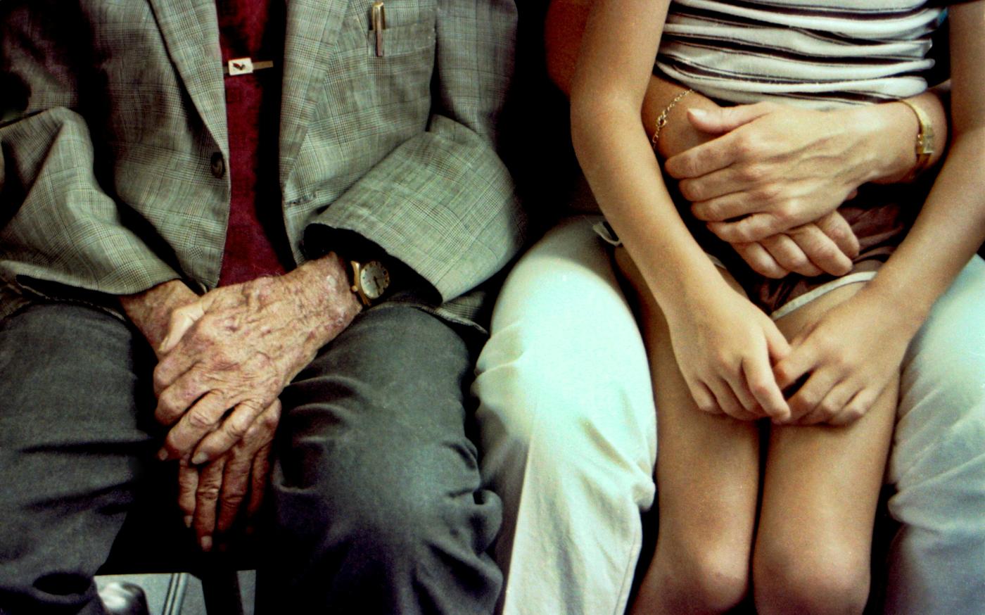 Grandfather's hands comfort a child. by Bill Fairs courtesy of Unsplash.