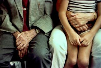 Grandfather's hands comfort a child. by Bill Fairs courtesy of Unsplash.